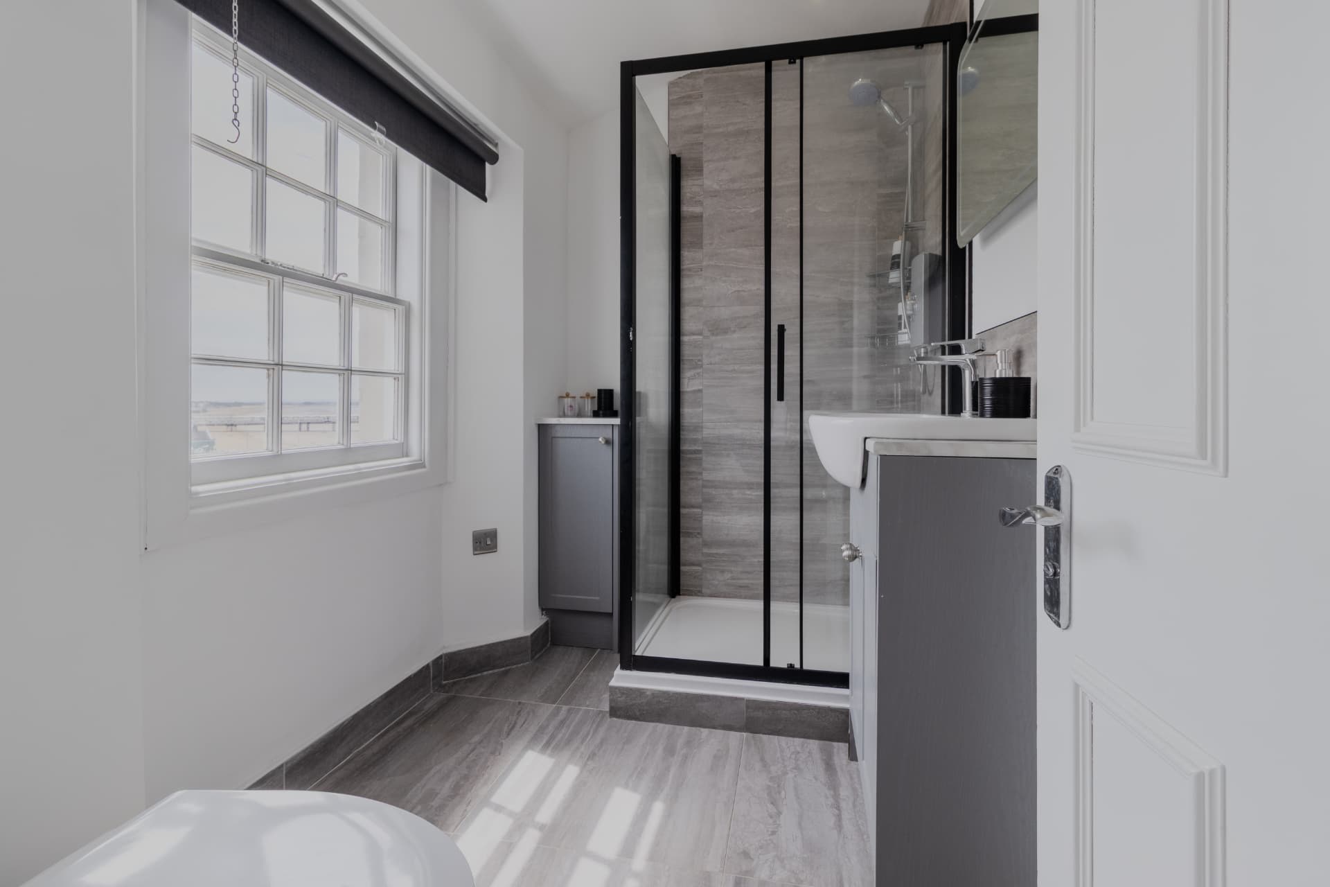 Second shower room with sea-facing sash window
